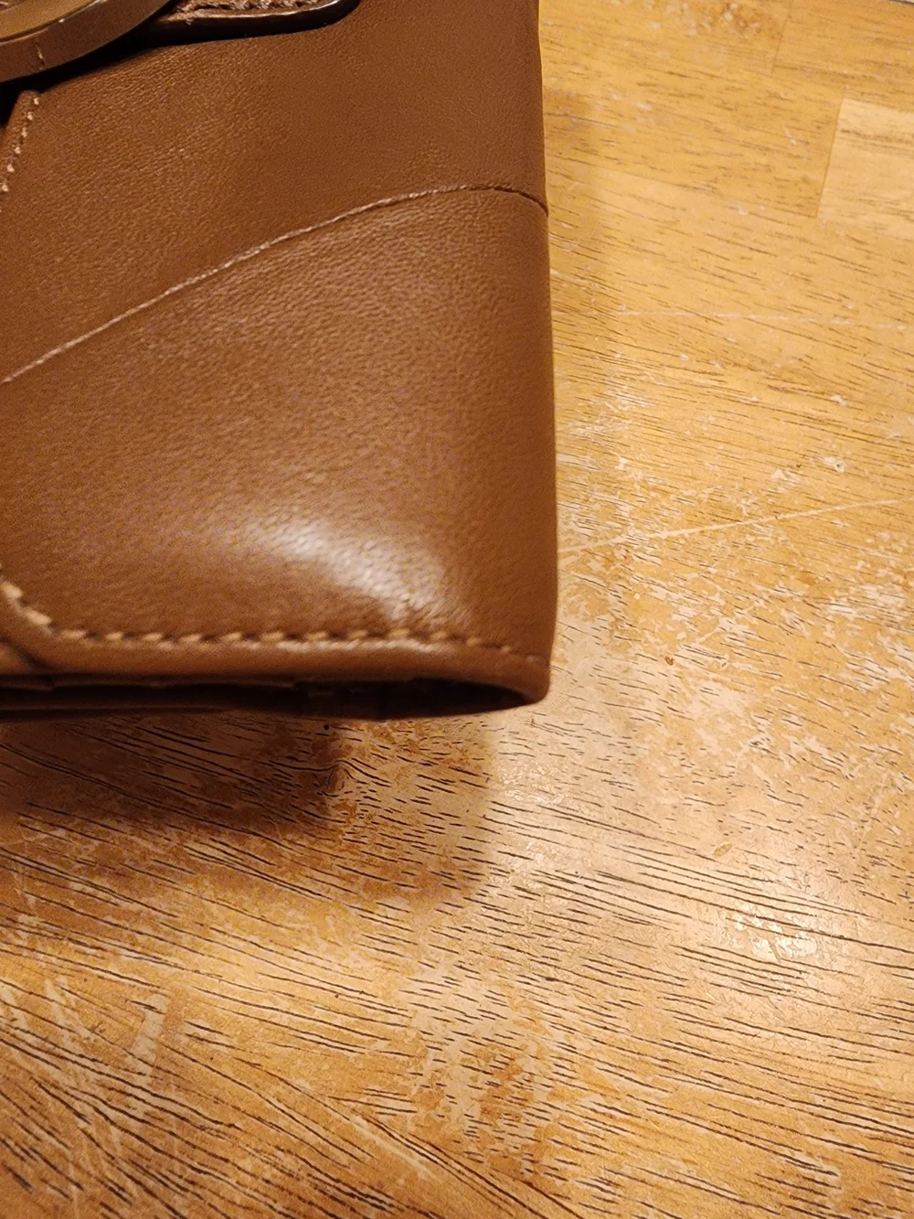vintage Coach Soho Buckle Wallet crafted in brown leather prominent front Buckle